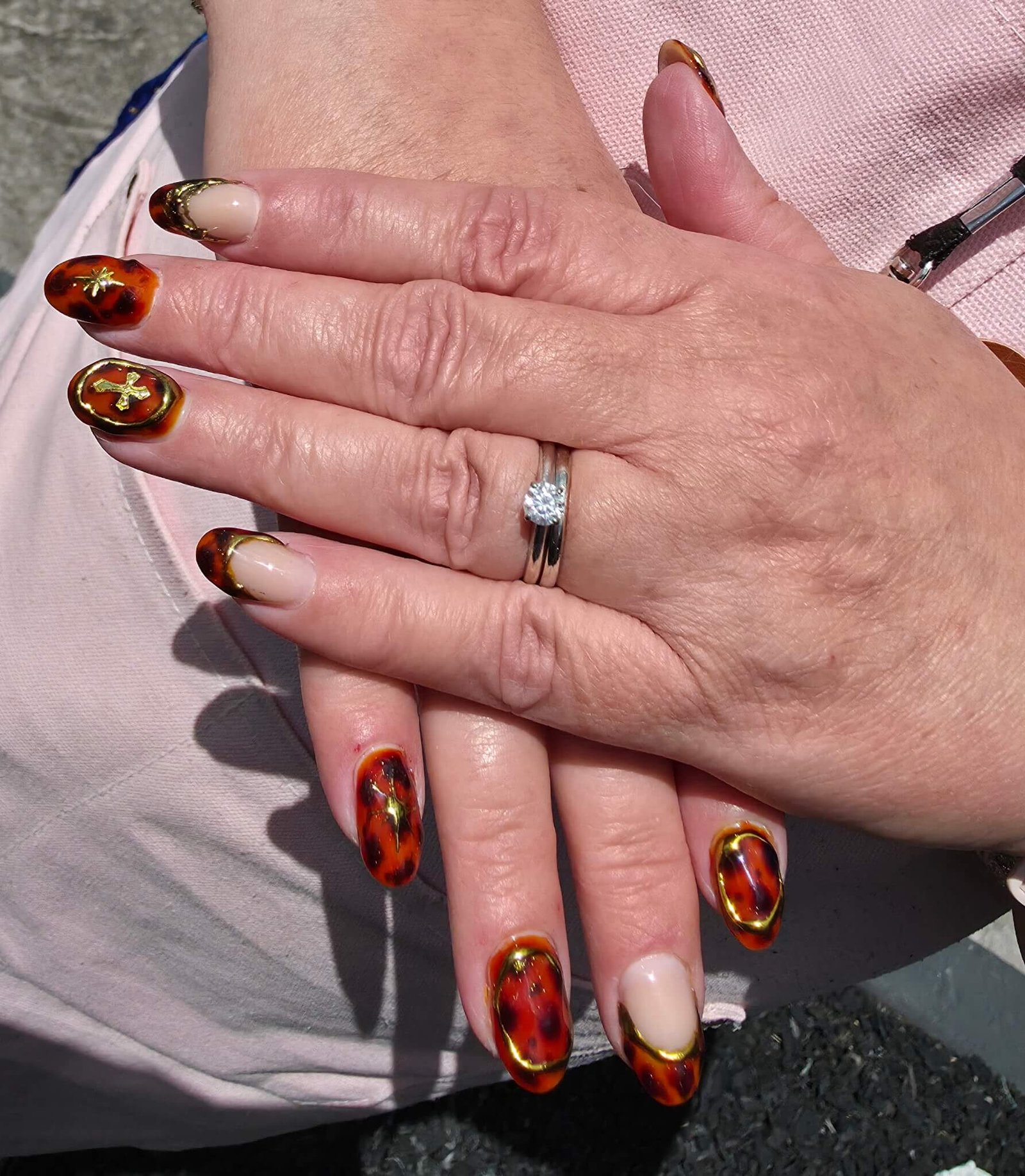 Tortoise and gold nail art on both hands